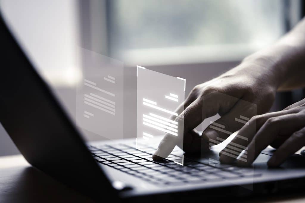 An employee working on documents on his laptop