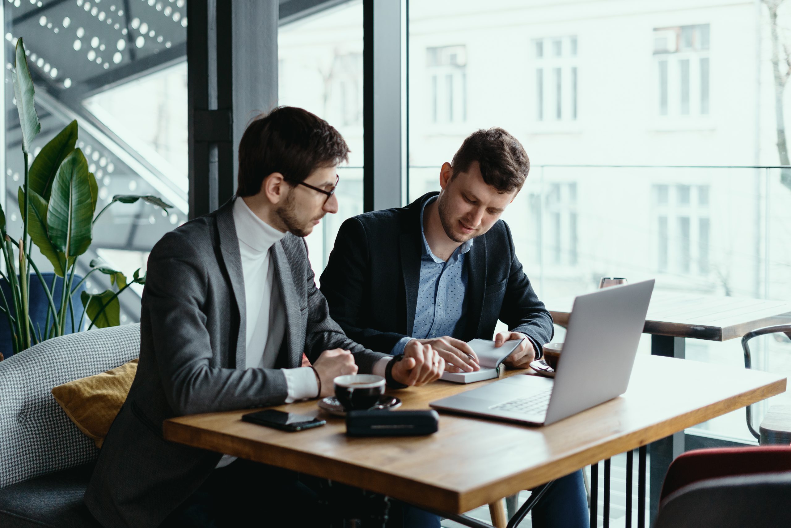 a pic of two young businessman having successful meeting placed in azdan referral program page